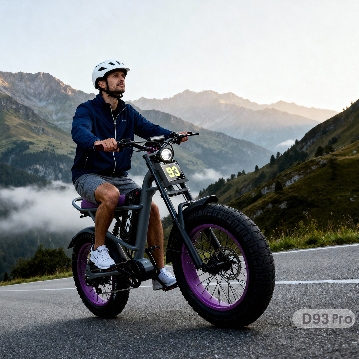 DRIFT.SLIDE D93 Pro purple fat tire electric bike lifestyle photo, man wearing helmet riding on mountain highway at sunrise, alpine mountain valley background, real‑world riding scene promotional image