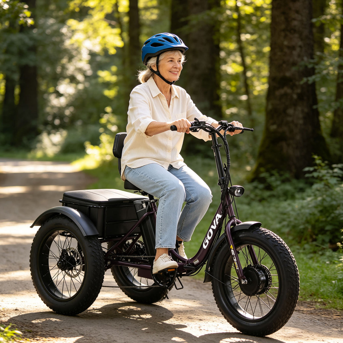  GS3 purple fat‑tire electric tricycle, senior woman riding on sunlit forest trail, comfortable stable three‑wheel e‑trike for elderly leisure lifestyle promotional photo